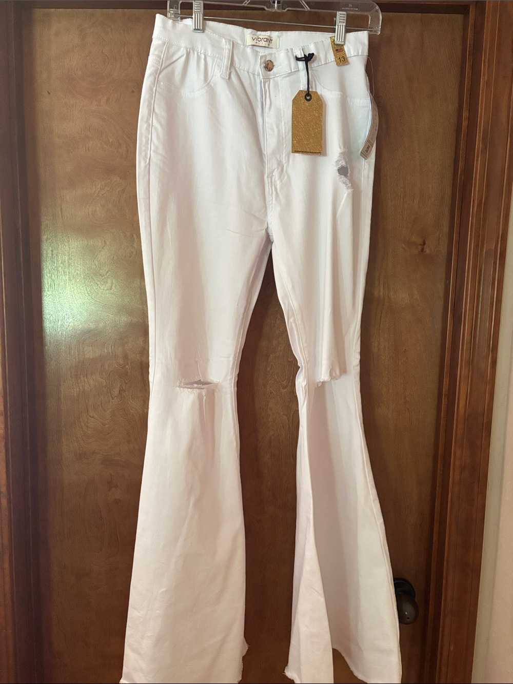 Vibrant White Flare Jeans with Distressed Knees